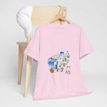 Santorini-inspired pink graphic tee on a chair, perfect for summer beach outings. Custom t-shirt from My Name Is POD.